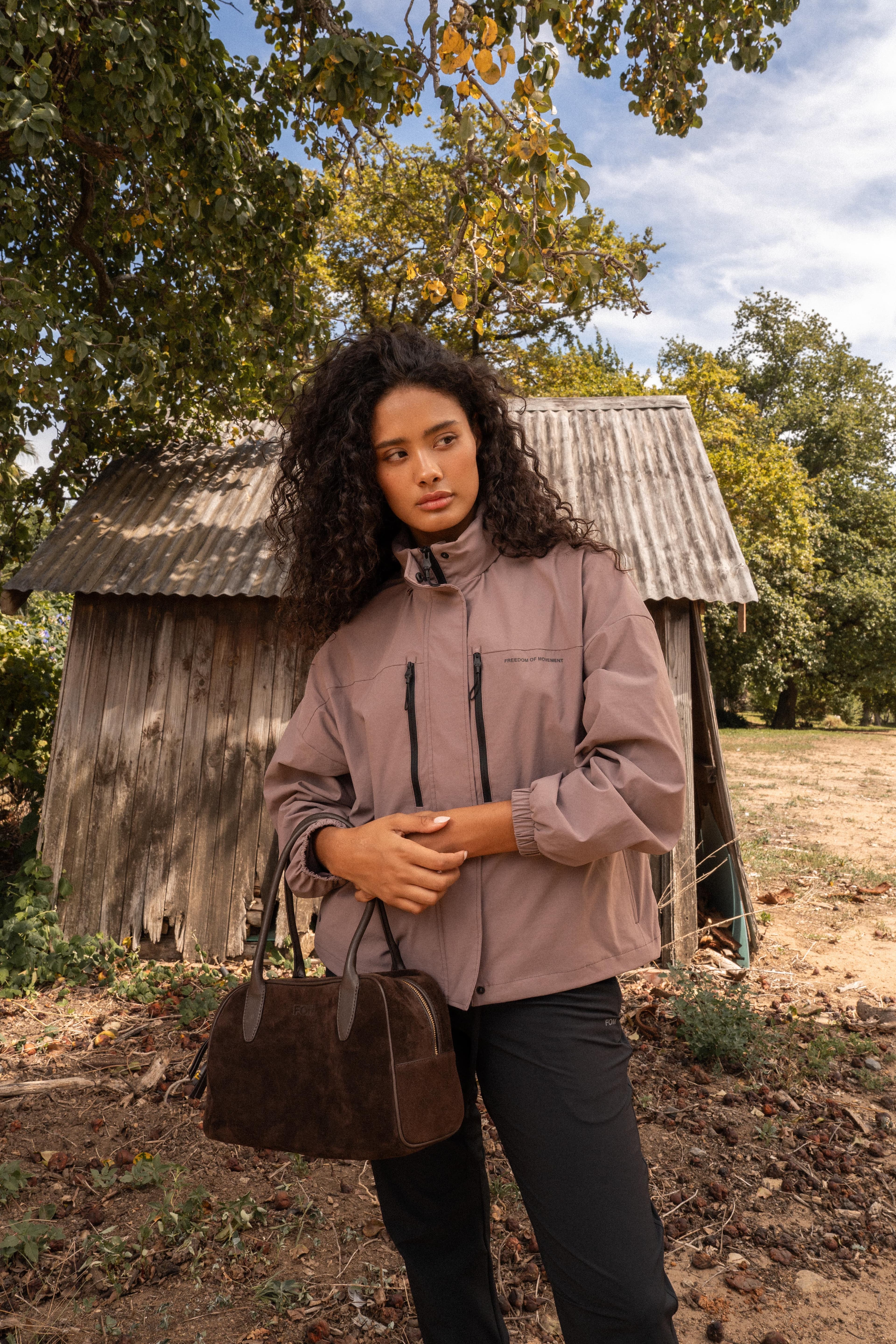 Editorial portrait in autumn light with leather bag